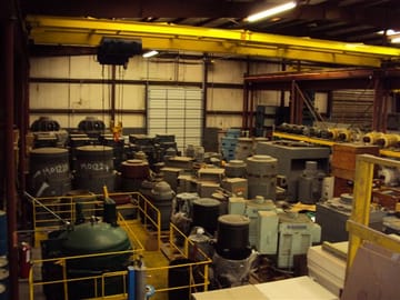 Vertical electric motors stored in the PMW warehouse under an overhead crane