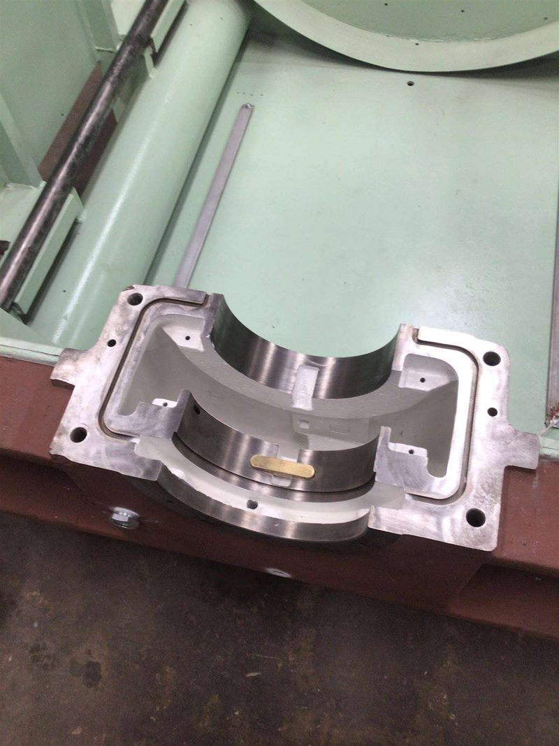 Split sleeve bearing seated in a machined bearing housing on the motor frame