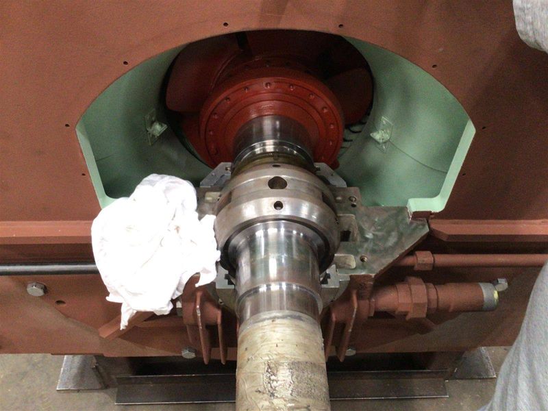 Shaft assembly viewed from below showing bearing housing and internal components within painted frame
